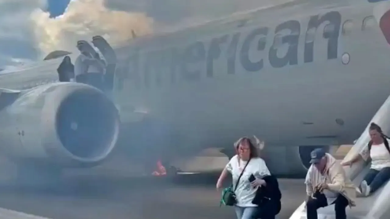 American Airlines plane catches fire, causing chaos on runway